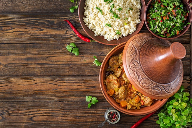 Traditional Tajine Dishes, Couscous And Fresh Salad On Rustic
